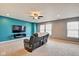 Spacious living room with a ceiling fan, carpet flooring, and a television mounted on an accent wall at 8316 S Swimming Hole Ln, Pendleton, IN 46064