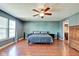 Spacious main bedroom with wood floors, ceiling fan, ensuite bathroom, and plenty of natural light at 8316 S Swimming Hole Ln, Pendleton, IN 46064