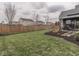Expansive backyard featuring lush green grass, wooden fencing, and tasteful landscaping, ideal for relaxation and recreation at 834 Bristle Lake Dr, Brownsburg, IN 46112