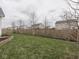 A well-maintained backyard features lush grass, a sturdy fence, and young trees, perfect for outdoor activities at 834 Bristle Lake Dr, Brownsburg, IN 46112