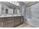 Bright bathroom features a double sink vanity, a bathtub with shower, and neutral decor at 834 Bristle Lake Dr, Brownsburg, IN 46112