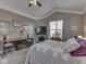 Cozy bedroom features vaulted ceiling with ceiling fan, fireplace and work area at 834 Bristle Lake Dr, Brownsburg, IN 46112
