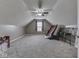 Large bonus room with sloped ceiling, carpeted floor, and great ceiling fan at 834 Bristle Lake Dr, Brownsburg, IN 46112