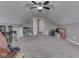 A spacious bonus room features neutral walls, plush carpeting, and a ceiling fan for added comfort at 834 Bristle Lake Dr, Brownsburg, IN 46112