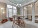 Cozy dining area with a chandelier, a round table, upholstered chairs, and a view of the front entry at 834 Bristle Lake Dr, Brownsburg, IN 46112