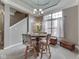 Cozy dining area with a chandelier, a round table, upholstered chairs, and a large window at 834 Bristle Lake Dr, Brownsburg, IN 46112