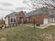 Beautifully landscaped brick home featuring a well-maintained lawn, shrubs and sidewalk leading to the entrance at 834 Bristle Lake Dr, Brownsburg, IN 46112
