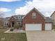 Charming brick home featuring a three-car garage, well-manicured landscaping, and a welcoming front entrance at 834 Bristle Lake Dr, Brownsburg, IN 46112
