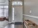 Bright foyer with a white front door, sidelights, transom window, hardwood floors, and neutral wall paint at 834 Bristle Lake Dr, Brownsburg, IN 46112