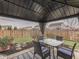 Gazebo offers a relaxing outdoor space with comfortable seating, lush plants, and a view of the fenced backyard at 834 Bristle Lake Dr, Brownsburg, IN 46112