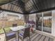 Cozy outdoor dining area in the gazebo featuring a stylish table, comfortable chairs, and a view of the backyard at 834 Bristle Lake Dr, Brownsburg, IN 46112