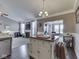 Open kitchen featuring an island with seating and sight lines into the Gathering room at 834 Bristle Lake Dr, Brownsburg, IN 46112