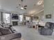 Spacious living room featuring a fireplace, built-in shelving, neutral paint, and large windows at 834 Bristle Lake Dr, Brownsburg, IN 46112