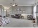 Bright and open living room with fireplace, neutral decor, and seamless flow into dining and entry areas at 834 Bristle Lake Dr, Brownsburg, IN 46112
