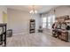 Cozy dining area features a bookshelf, storage, and natural light from the window at 8610 Fawn Way, McCordsville, IN 46055
