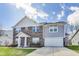 Traditional two-story home features a two-car garage and brick and siding exterior at 8610 Fawn Way, McCordsville, IN 46055