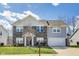 Inviting two-story home boasts a brick facade, manicured lawn, and attached two-car garage at 8610 Fawn Way, McCordsville, IN 46055