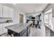 Open-concept kitchen featuring granite countertops, an island, and view into the living room at 8610 Fawn Way, McCordsville, IN 46055