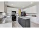 Well-lit kitchen featuring granite countertops, stainless steel appliances, and gray wood-look flooring at 8610 Fawn Way, McCordsville, IN 46055