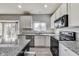 Modern kitchen features granite countertops, stainless steel appliances, and wood-look flooring at 8610 Fawn Way, McCordsville, IN 46055