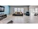 Bright living room featuring gray wood-look flooring, comfortable seating, and natural light at 8610 Fawn Way, McCordsville, IN 46055