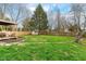 A well-manicured backyard featuring a shed, a wooden fence, and lush green grass at 8829 Depot Dr, Indianapolis, IN 46217