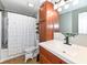 Functional bathroom featuring a shower with curtain, toilet, vanity, and cabinet for storage at 8829 Depot Dr, Indianapolis, IN 46217