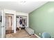 A bedroom with green walls, a closet filled with items, and a cushioned bench for seating at 8829 Depot Dr, Indianapolis, IN 46217