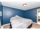 Inviting bedroom has soothing paint color and soft carpet at 8829 Depot Dr, Indianapolis, IN 46217