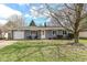 Charming ranch style home with well-manicured lawn, blue siding, and a welcoming front door wreath at 8829 Depot Dr, Indianapolis, IN 46217
