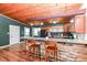 Kitchen featuring a breakfast bar, wood cabinets, and stainless steel appliances at 8829 Depot Dr, Indianapolis, IN 46217
