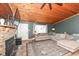 Cozy living room showcasing a wood ceiling, stone fireplace, and ample natural light at 8829 Depot Dr, Indianapolis, IN 46217