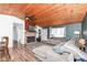Inviting living room features a stone fireplace, wood ceiling, ceiling fan and comfortable seating at 8829 Depot Dr, Indianapolis, IN 46217