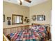 Cozy bedroom featuring wainscoting, mirror, and quilt bedding in a decorative and inviting setting at 9255 W 30Th St, Indianapolis, IN 46234
