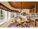 A dining area joins the kitchen with a beautiful stained glass chandelier at 9255 W 30Th St, Indianapolis, IN 46234