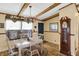 Inviting dining room with hardwood floors and exposed wood beams offers a cozy atmosphere at 9255 W 30Th St, Indianapolis, IN 46234