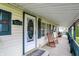 Inviting front porch with classic rocking chairs, perfect for relaxing and enjoying the outdoors at 9255 W 30Th St, Indianapolis, IN 46234