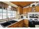 Traditional kitchen featuring wooden cabinets, a black sink, and updated appliances at 9255 W 30Th St, Indianapolis, IN 46234