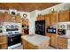Functional kitchen with wood cabinets, center island, and modern appliances at 9255 W 30Th St, Indianapolis, IN 46234