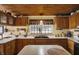 The kitchen has wood cabinets, a black sink, and solid surface countertops at 9255 W 30Th St, Indianapolis, IN 46234