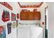 The laundry room has white appliances and Coca-Cola-themed decor at 9255 W 30Th St, Indianapolis, IN 46234