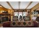 Cozy living room boasts a stone fireplace, wood paneling, exposed wood beams and comfortable seating area at 9255 W 30Th St, Indianapolis, IN 46234