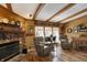 Bright living room with wood beams, a stone fireplace, and comfortable seating, perfect for relaxing at 9255 W 30Th St, Indianapolis, IN 46234