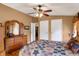 Comfortable main bedroom featuring a ceiling fan, dresser, and wood flooring with natural light at 9255 W 30Th St, Indianapolis, IN 46234