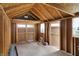 Unfinished interior of a storage shed, featuring exposed wood framing, two doors, and ample natural light at 9255 W 30Th St, Indianapolis, IN 46234