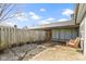Backyard area featuring a concrete patio, wooden fence, and an outdoor storage unit at 9464 Fordham St, Indianapolis, IN 46268