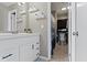 Well-lit bathroom featuring a white vanity with shelving and a view into the toilet and cabinet at 9464 Fordham St, Indianapolis, IN 46268