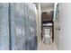 Neutral bathroom with a white toilet, towel cabinet, and decorative blue and gray shower curtain at 9464 Fordham St, Indianapolis, IN 46268