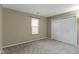 Simple bedroom with neutral walls, carpet, a window, and a double door closet at 9464 Fordham St, Indianapolis, IN 46268