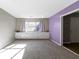 Bonus room with purple accent wall, built-in cabinets, and large window at 9464 Fordham St, Indianapolis, IN 46268